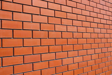 Red brick wall. Close-up. Perspective. Background. Texture.