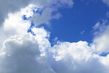 Naklejka na ściany i meble Beautiful blue sky and large white cumulus clouds. Background. Scenery. Texture.