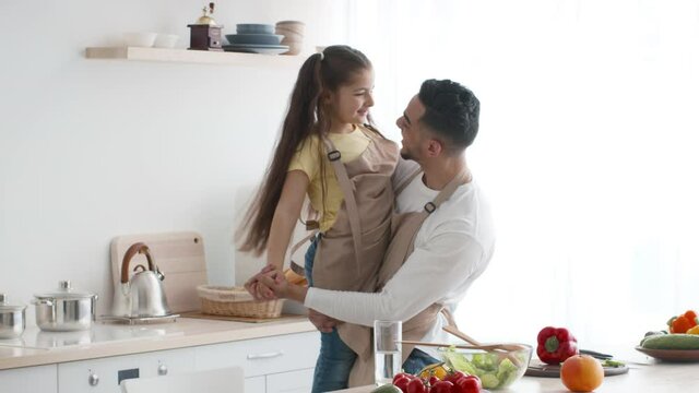 Middle-Eastern Daddy And Little Daughter Dancing Having Fun In Kitchen