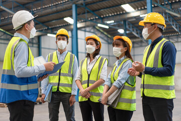 Group of Asian male and female engineers wearing hygienic mask protect with helmet safety in factory Industrial.Coronavirus Protective, safety concept