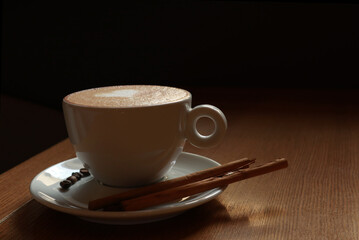 Cup with tasty coffee and milk on table      