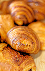 Close-up with fresh golden croissants on a plate