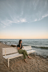 Fototapeta premium Lonely woman on the beach. COncept photo of depressed emotion and loneliness