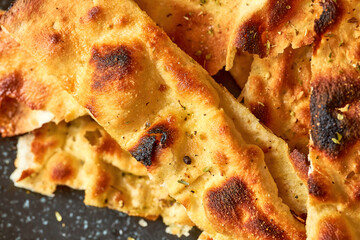 Traditional Italian bread from the oven - focaccia on a gray plate. Top view, close up