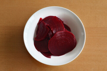 Top view of pickled red beet salad in bowl