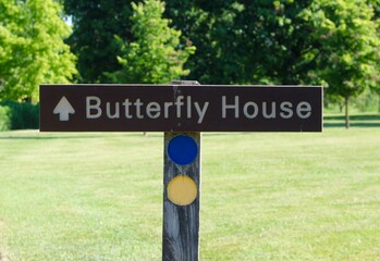 A close view of the butterfly house sign in the park.