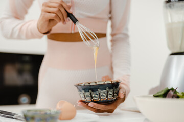 Cropped photo of black woman cooking in kitchen at home