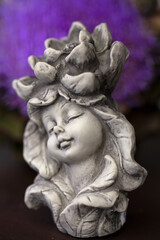 Fototapeta na wymiar Little figurine of a fairy girl for outdoor garden decoration