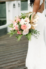 African American bride holding tropical flower bouquet