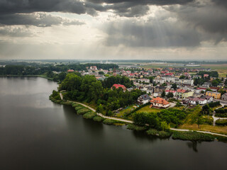 Fototapeta premium Flight over the lake and view of the city. 