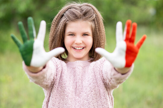 Mexico flag painted on teen girl hands, focus on smile face. Mexican Independence Day 16 September. February 5 Day of Conference. February 24 National Flag Day