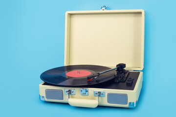 Vintage vinyl record player isolated on blue background