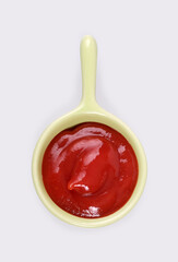 Small trial portion of classic ketchup on platter isolated on white background. Design element with clipping path