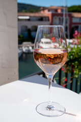 Summer on French Riviera Cote d'Azur, drinking cold rose wine from Cotes de Provence on outdoor terrase in Port Grimaud, Var, France