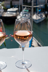 Summer on French Riviera Cote d'Azur, drinking cold rose wine from Cotes de Provence on outdoor terrase in Port Grimaud, Var, France