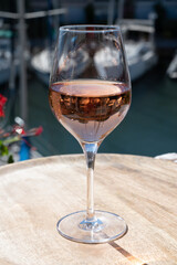 Summer on French Riviera Cote d'Azur, drinking cold rose wine from Cotes de Provence on outdoor terrase in Port Grimaud, Var, France