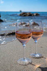 Summer time in Provence, two glasses of cold rose wine on sandy beach near Saint-Tropez, Var department, France