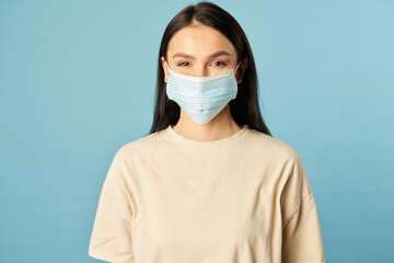 Beautiful female posing in a disposable protective mask from viruses