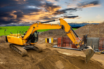 excavator working on construction site with dramatic sky