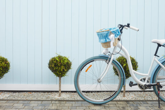 Cute white bike with busket on blue wall. South side near sea.