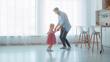 Dancing young father and little preschool girl