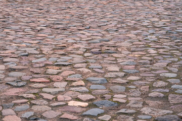 Gray cobblestone with blue and red pieces. Background image.