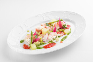 Avocado and Shrimps Salad on white plate isolated on white background