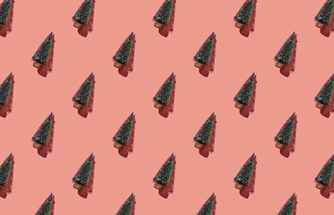 Pattern of christmas trees on pink pastel background