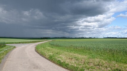 Little country road under a threatening sky