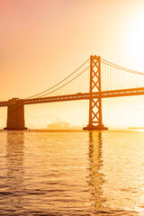 Incredible view of the Oakland Bay Bridge and the waterfront in San Francisco at sunrise, photographed from the pier