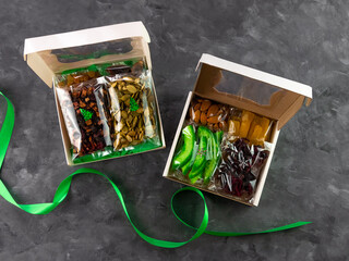 Gift box with set of different dried fruits nuts citrus individually wrapped flat lay. Healthy food...