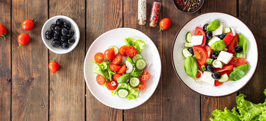 different salads vegetables, grilled chicken breast, olives, feta, tomato, onion, cucumber other on the table, healthy food