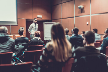 Skiled Public Speaker Giving a Talk at Business Meeting.