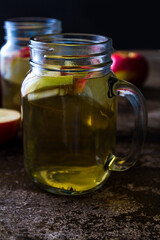 Fototapeta na wymiar A refreshing jug of apple cider on wood table