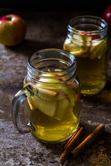 Fototapeta na wymiar A refreshing jug of apple cider on wood table