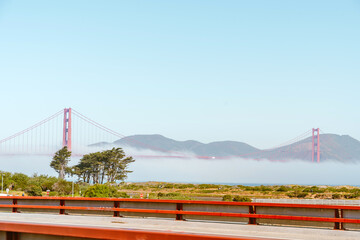 Fototapeta na wymiar Golden Gate Bridge in the fog, photo taken from the embankment, San Francisco