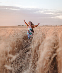 girl running in the wheat field