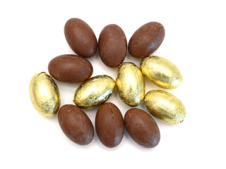 Chocolate easter eggs in colorful foil on white background