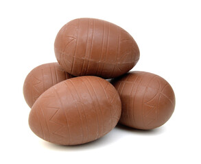 Chocolate easter eggs in colorful foil on white background