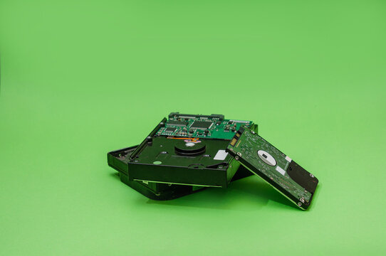 Bunch of HDD on a green background. Mining on hard disk drives concept. Repair service concept
