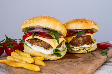 Homemade Beef Burger with Cheese and Chips on wooden background