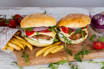 Homemade Beef Burger with Cheese and Chips on wooden background