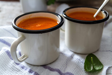 Carrot soup on a table in mugs. Homemade healty food