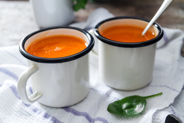 Carrot soup on a table in mugs. Homemade healty food