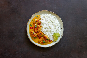 Chicken tikka masala curry with rice, herbs and peppers. Indian food. National cuisine.