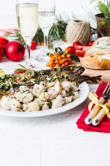 Roasted whole mackerel fish stuffed with vegetables and almonds on wooden table for christmas-top view. Italian Food