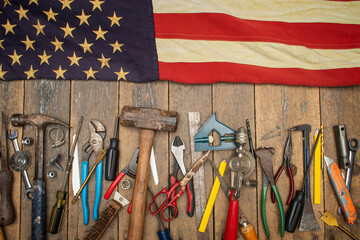 Antique American flag above a set of tools on a old workbench