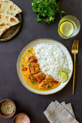 Chicken tikka masala curry with rice, herbs and peppers. Indian food. National cuisine.