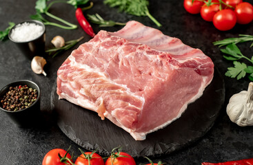 Raw whole pork steaks with ribs on stone background