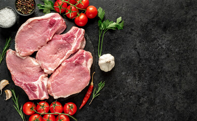 Raw pork steaks with ribs on stone background with copy space for your text

